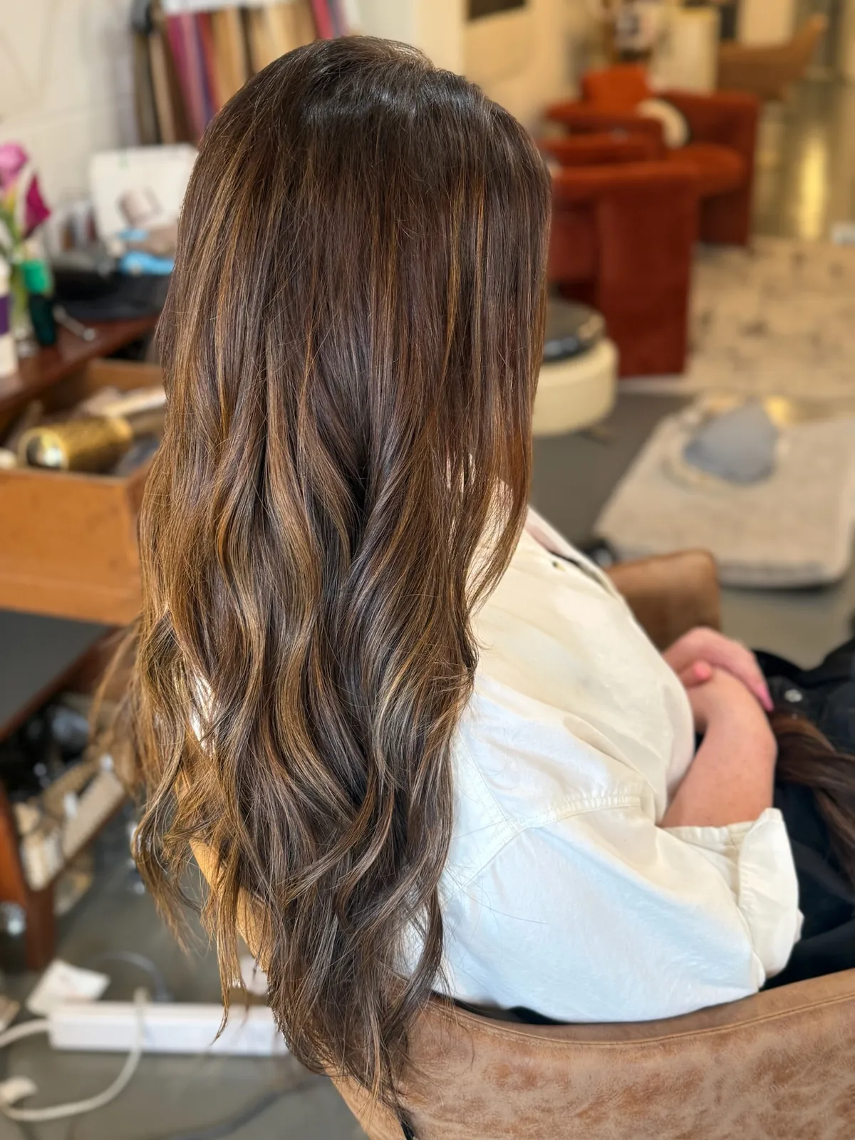 After: long brunette balayage waves.