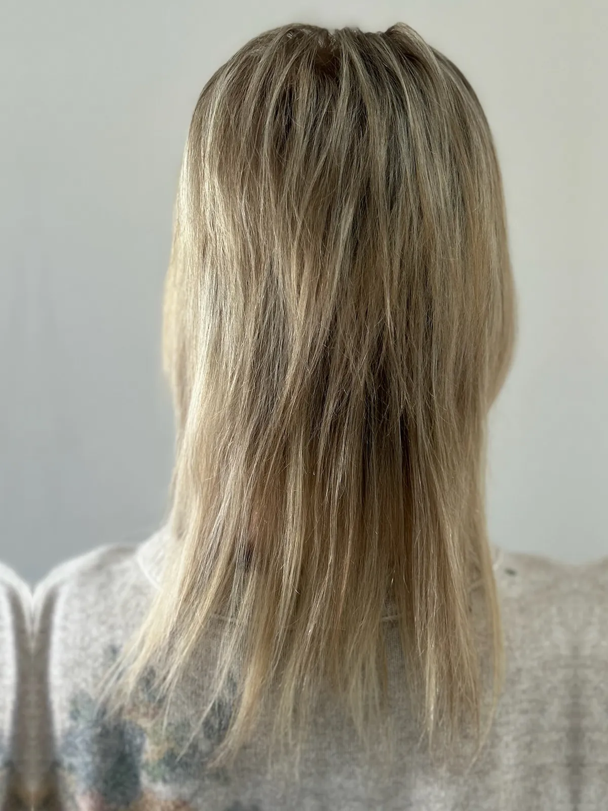 Before: choppy layered blonde hair.