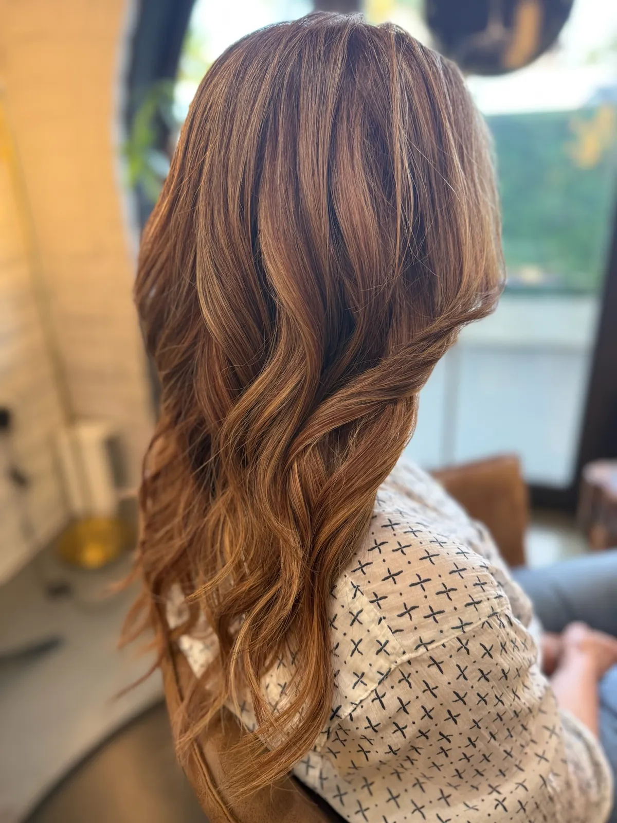 After: fuller auburn brown hair in soft waves.