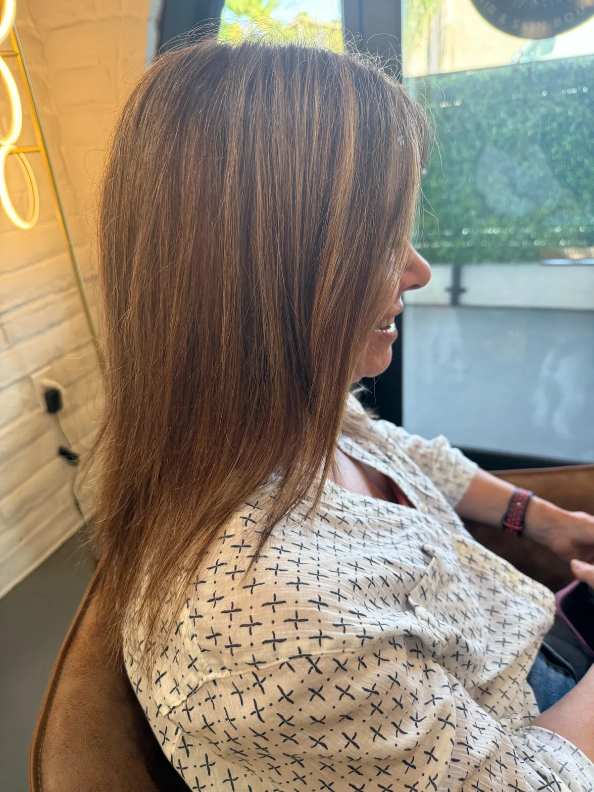 Before: straight auburn brown hair past the shoulders, from the side.
