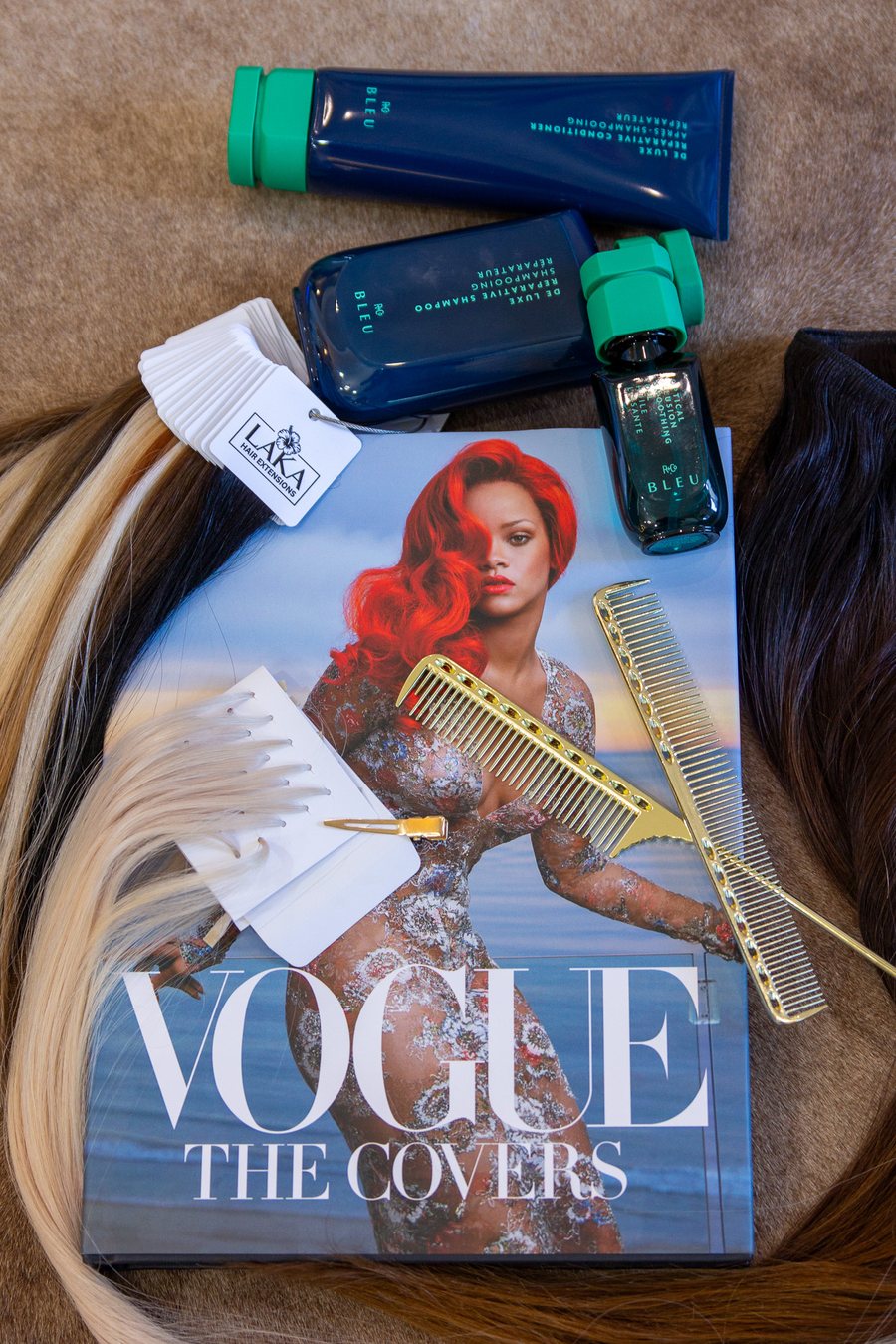 Extension wefts and product laid out beside a Vogue book.