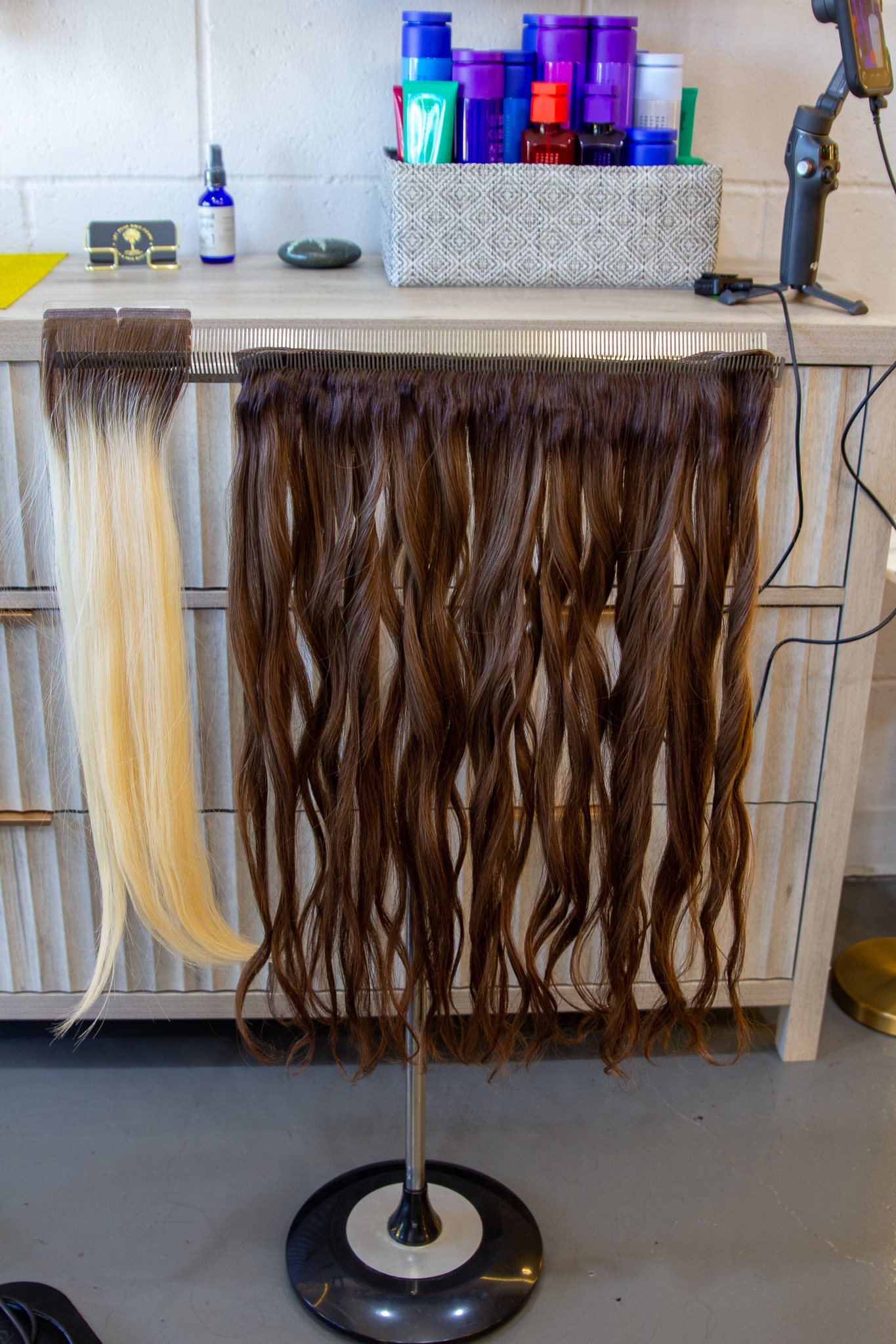 A rack of extension hair hanging in the salon.